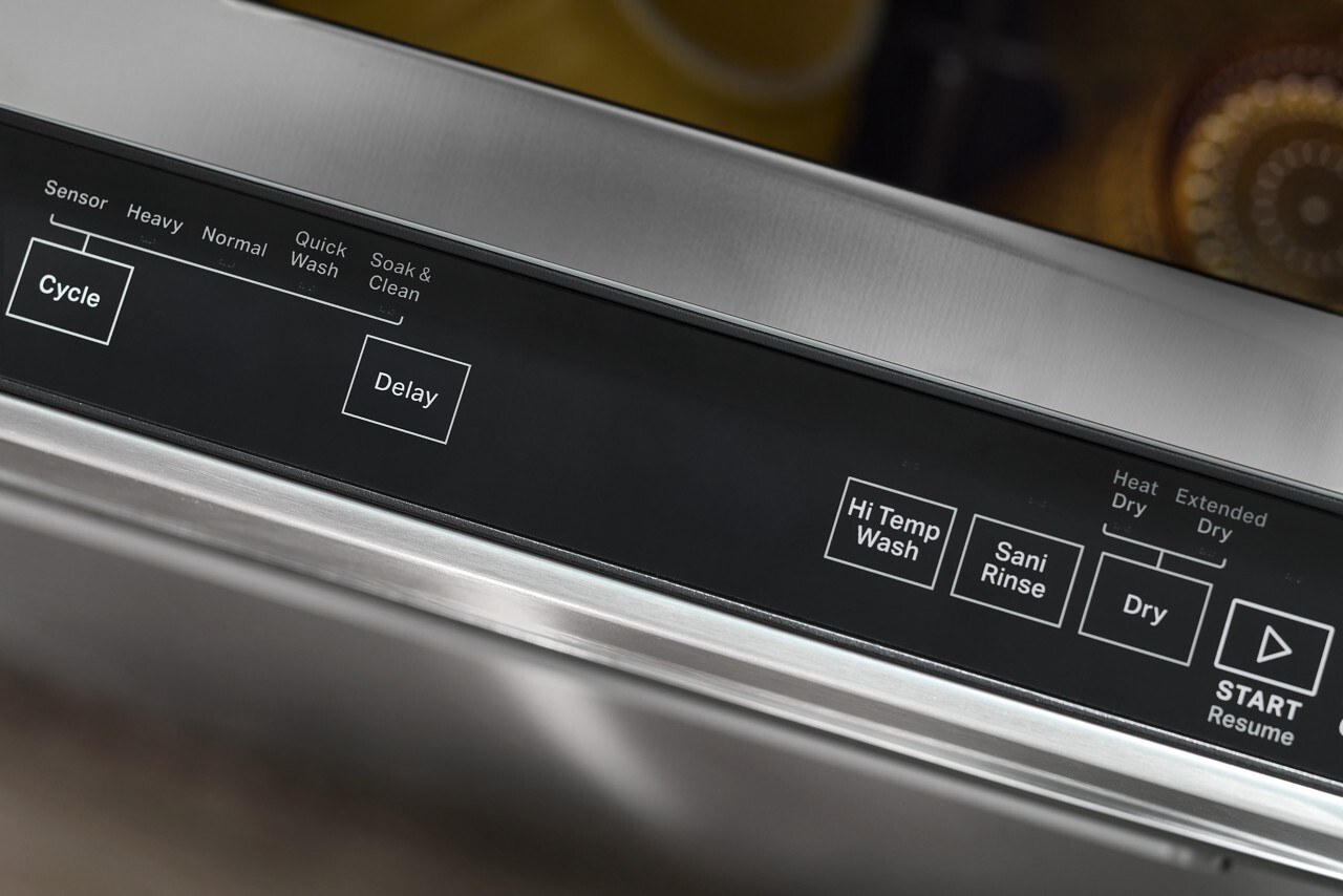 Whirlpool WDTA50SAKT built-in dishwasher with hidden control console door panel and clean biscuit finish exterior.