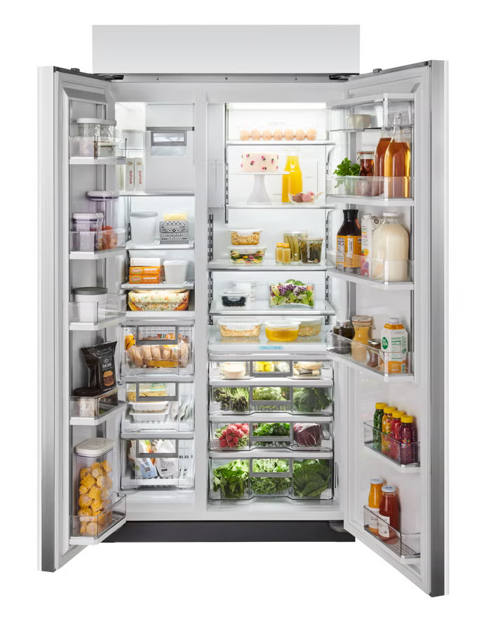 Interior or angled view of Sub-Zero CL4250SIDST showing the side-by-side interior layout and stainless steel finish with tubular handles, fully stocked.