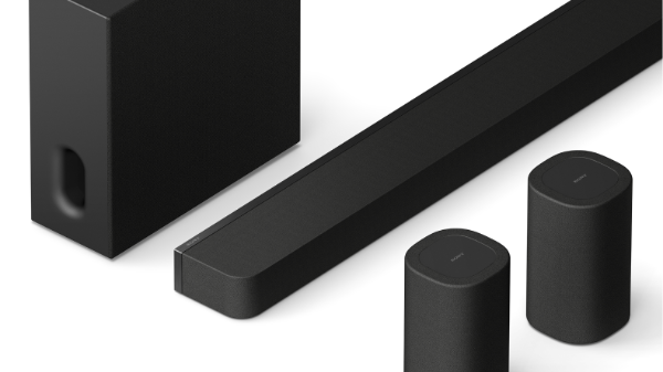 Sony SA-SW8 subwoofer positioned beside a sofa in a modern, softly lit living room