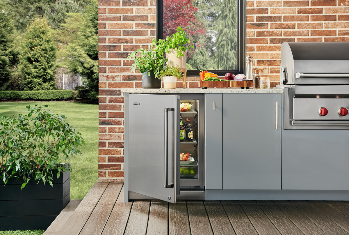 Sub-Zero DEU2450RO/L Designer Series Outdoor Undercounter Refrigerator shown in a luxury built-in outdoor kitchen setting