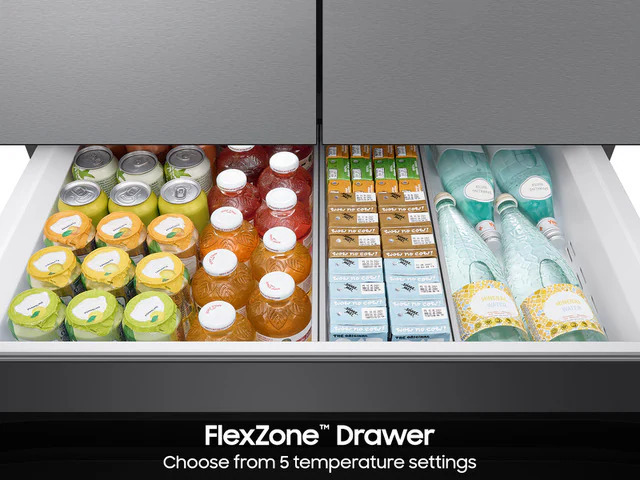 Open FlexZone Drawer of the Samsung Bespoke AI Refrigerator RF70F29DERAA, fully stocked with assorted canned beverages, bottled drinks, juice boxes, and bottled water, demonstrating flexible storage across two temperature zones.
