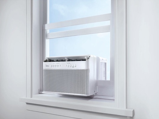 A window air conditioner sitting in a window.